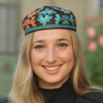An image of Cantor Magda Fishman wearing a Bukharan type kippah.