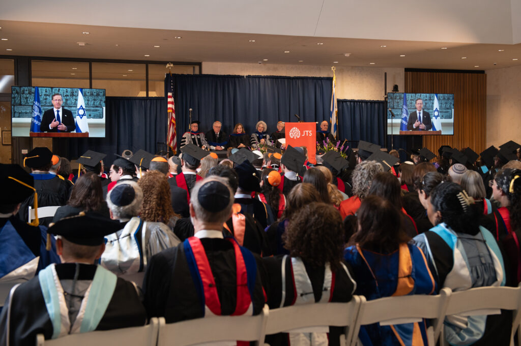 Full audience watching President Herzog's commencement speech.