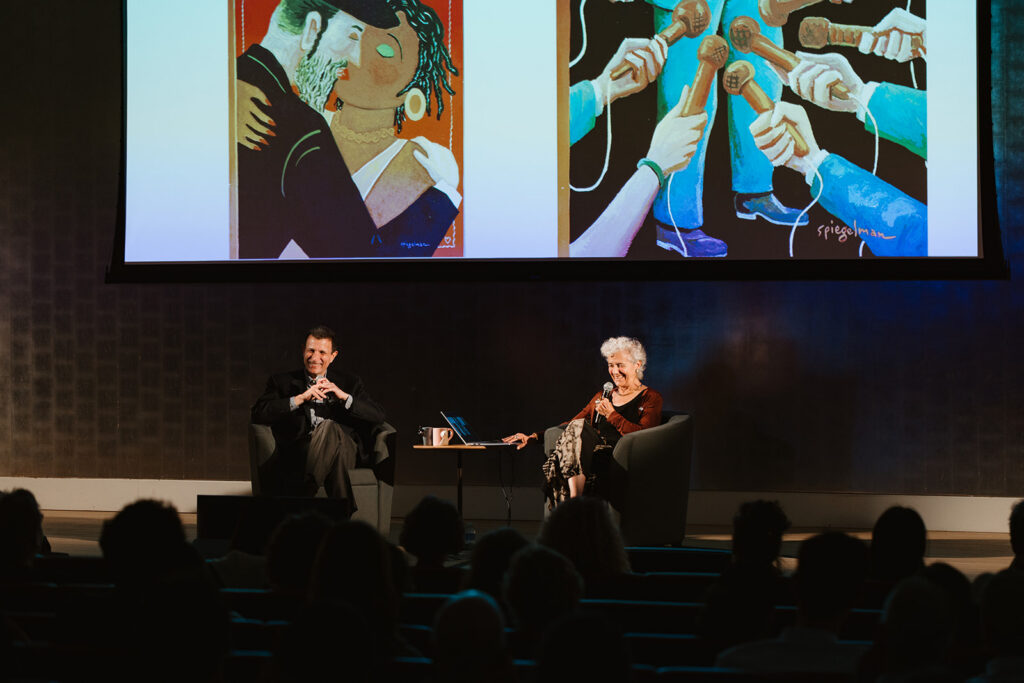 David Remnick and Françoise Mouly onstage with New Yorker covers in background